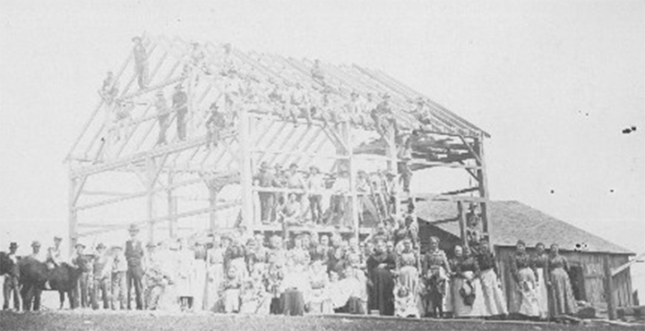 An image of a barn raising in Indiana in 1900.